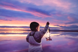 a little boy that is holding a light