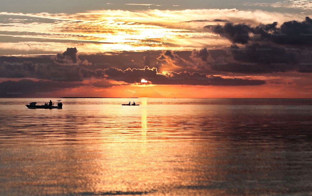 a couple of boats floating on top of a large body of water