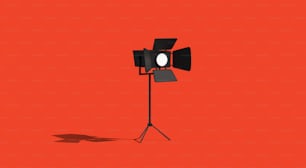 a light that is on a tripod on a red background