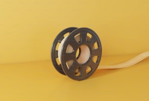 a reel with a spool of thread on a yellow background