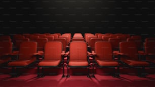 a row of red chairs sitting in front of a black wall
