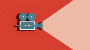 an overhead view of a movie camera on a red and pink background