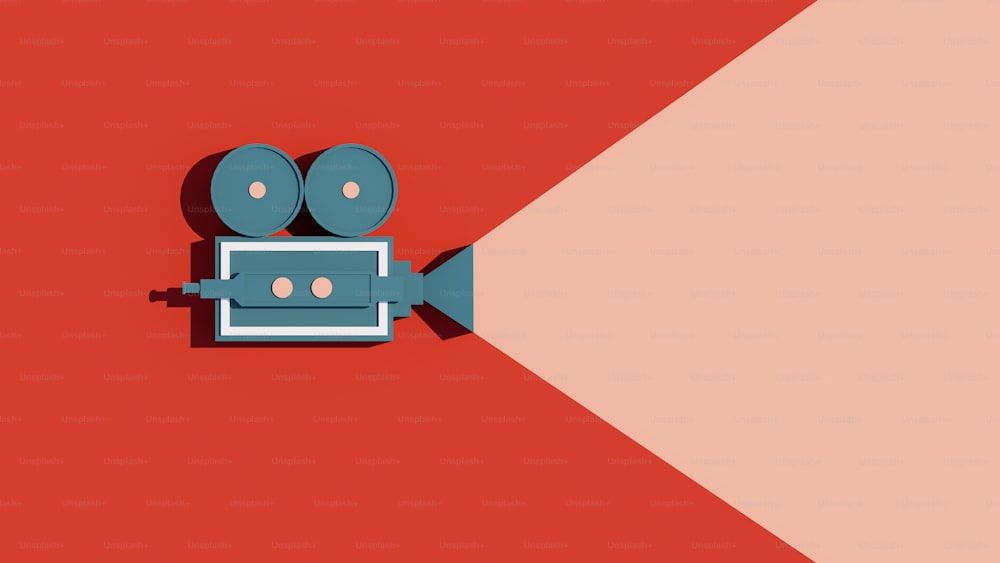 an overhead view of a movie camera on a red and pink background