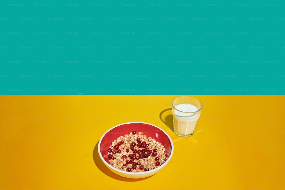 a bowl of cereal next to a glass of milk