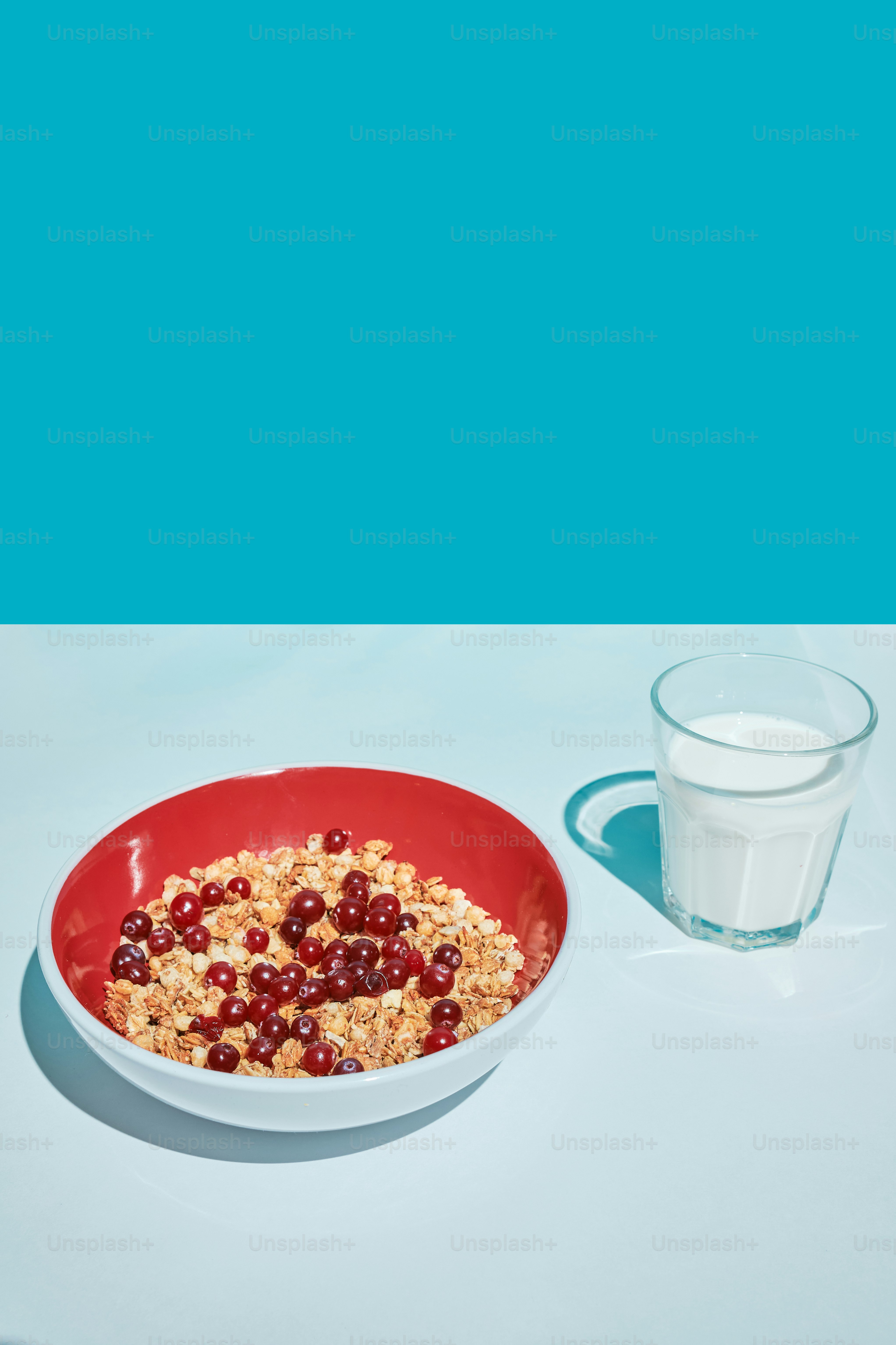 a bowl of cereal next to a glass of milk