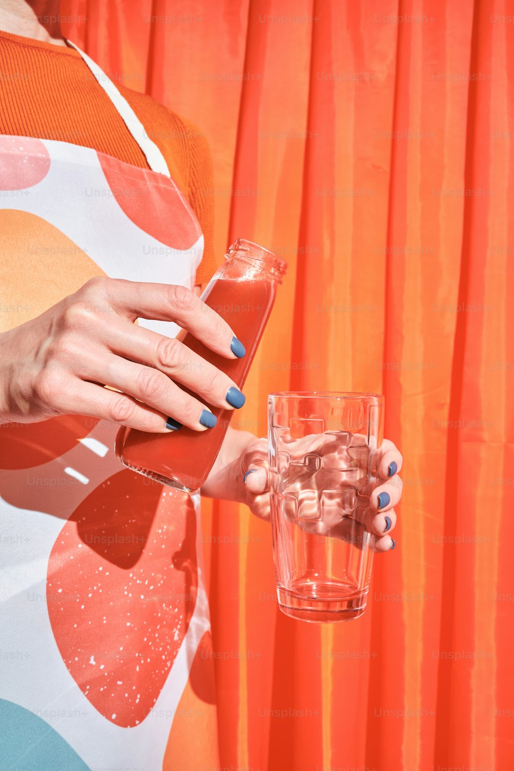 a woman is holding a glass of water