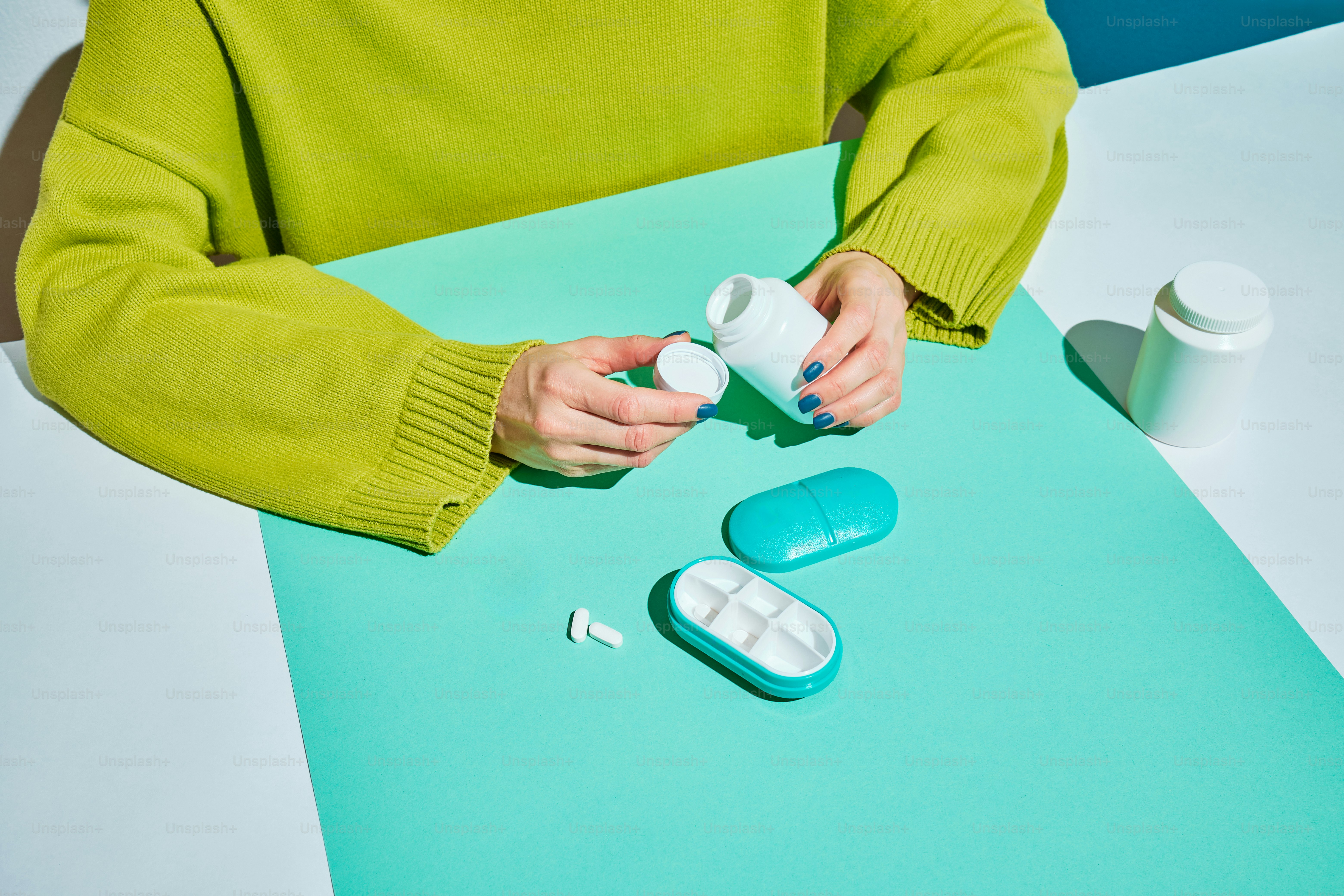 a woman is holding a bottle of pills