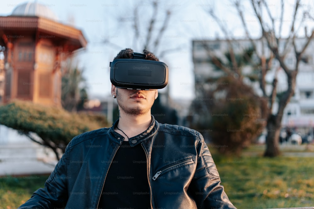 a man in a leather jacket wearing a virtual headset