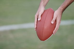 a close up of a person holding a football