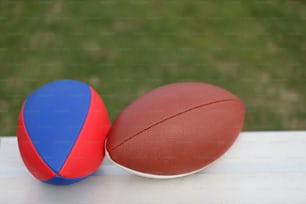 a close up of two sports balls on a table