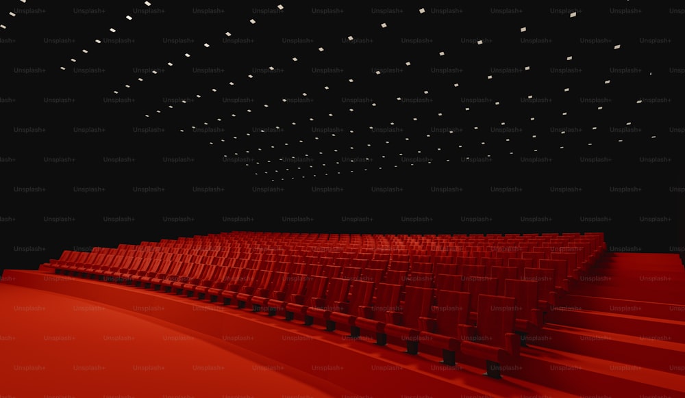 a large auditorium with rows of red seats