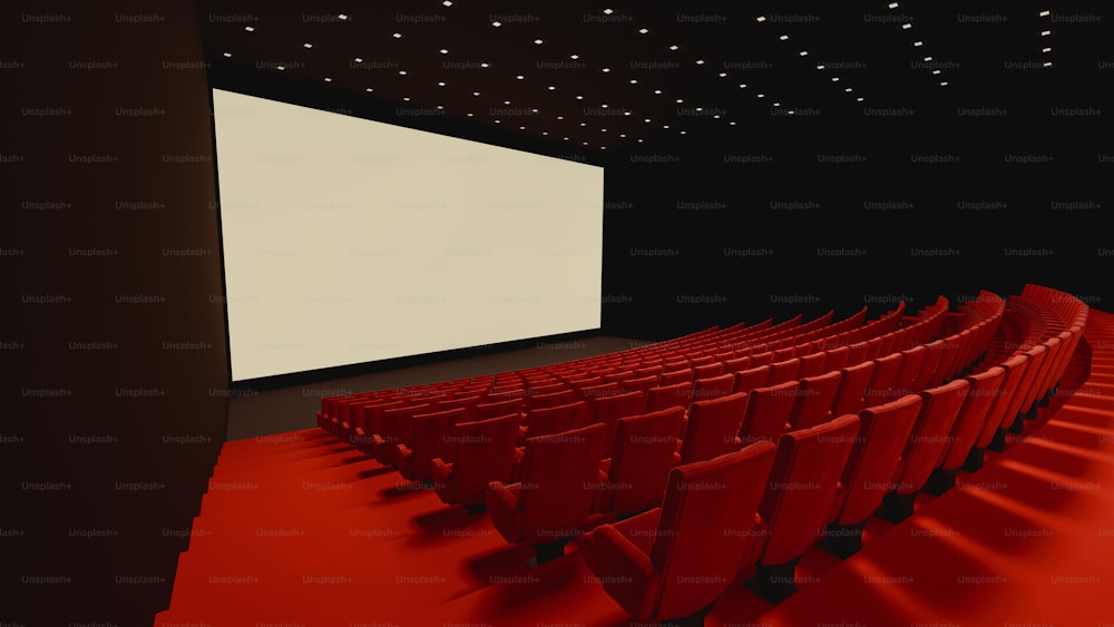 a red carpeted room with rows of red chairs in front of a large screen