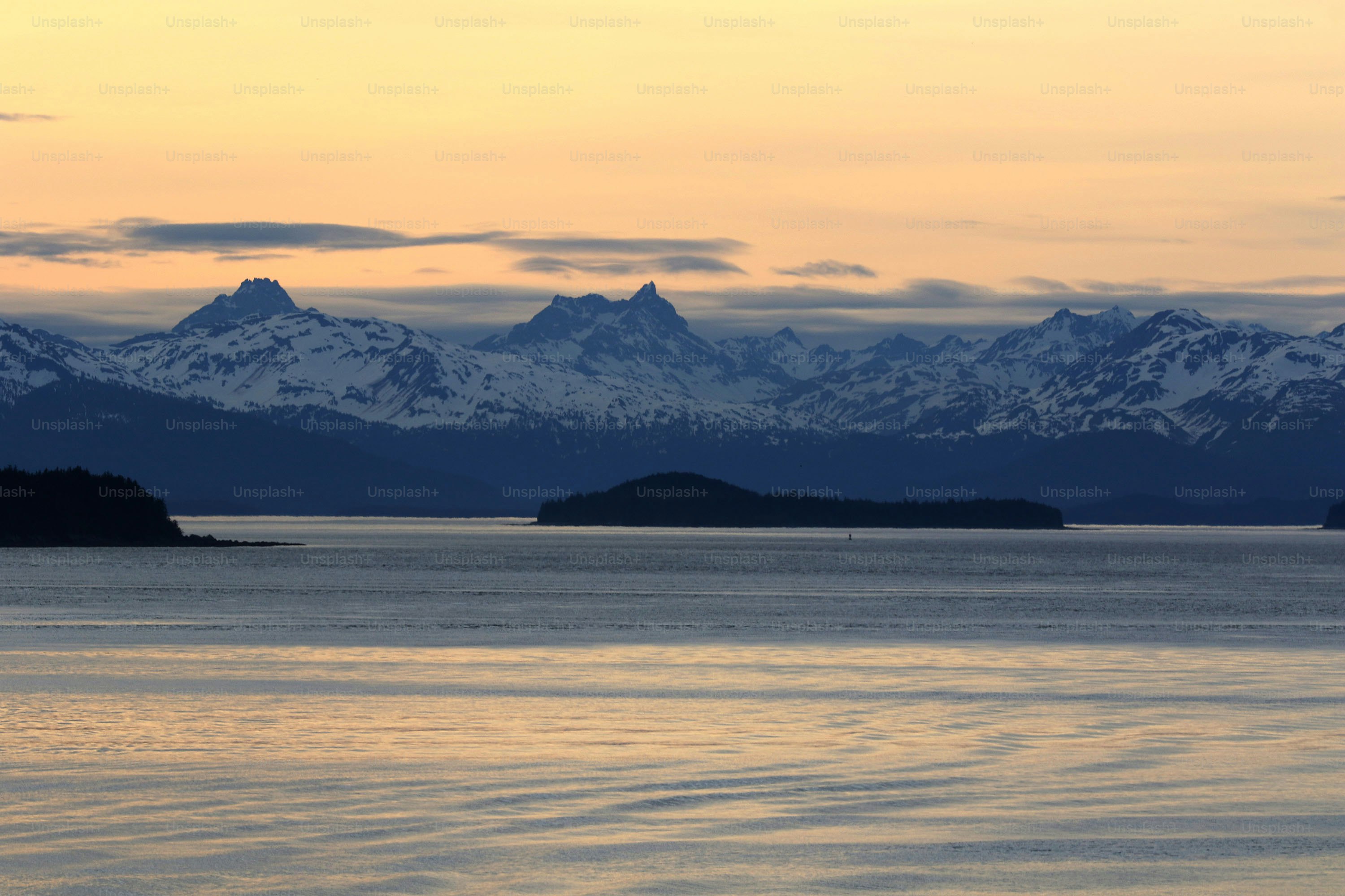 a large body of water with mountains in the background
