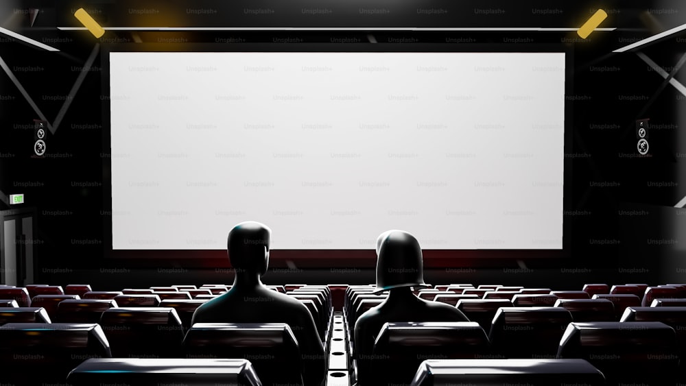 Dos personas están sentadas en una sala de cine