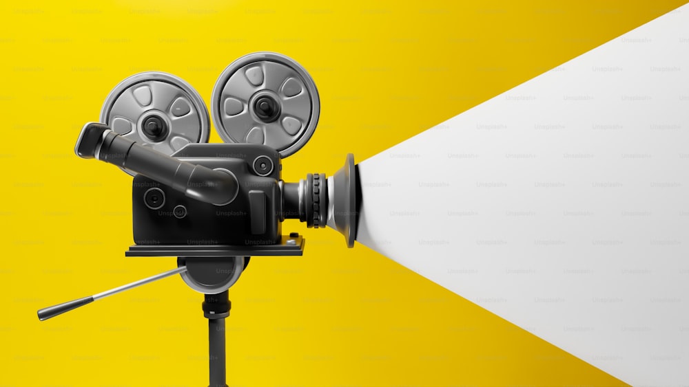 a movie projector on a tripod with a yellow background