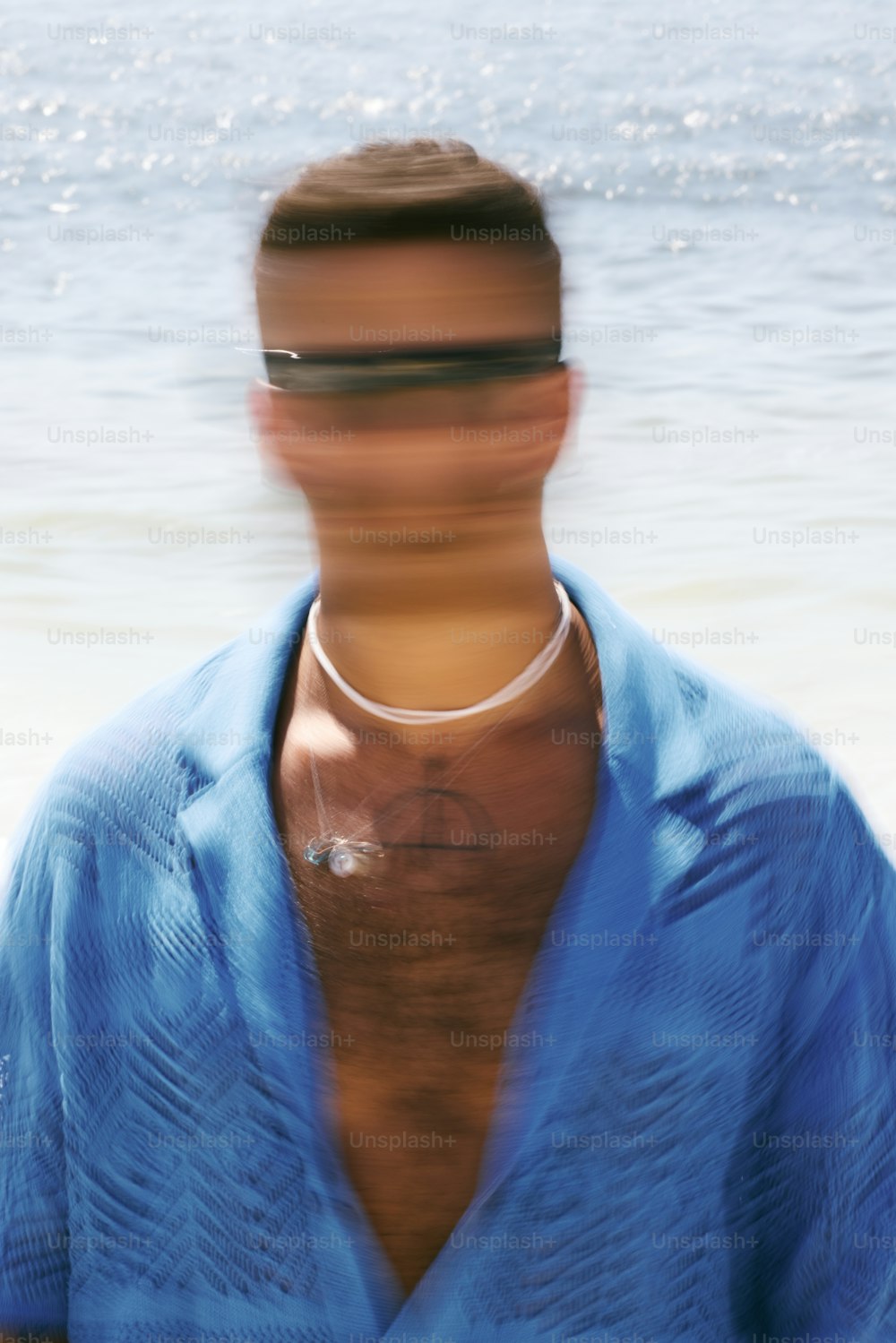 a blurry photo of a man wearing a blue shirt