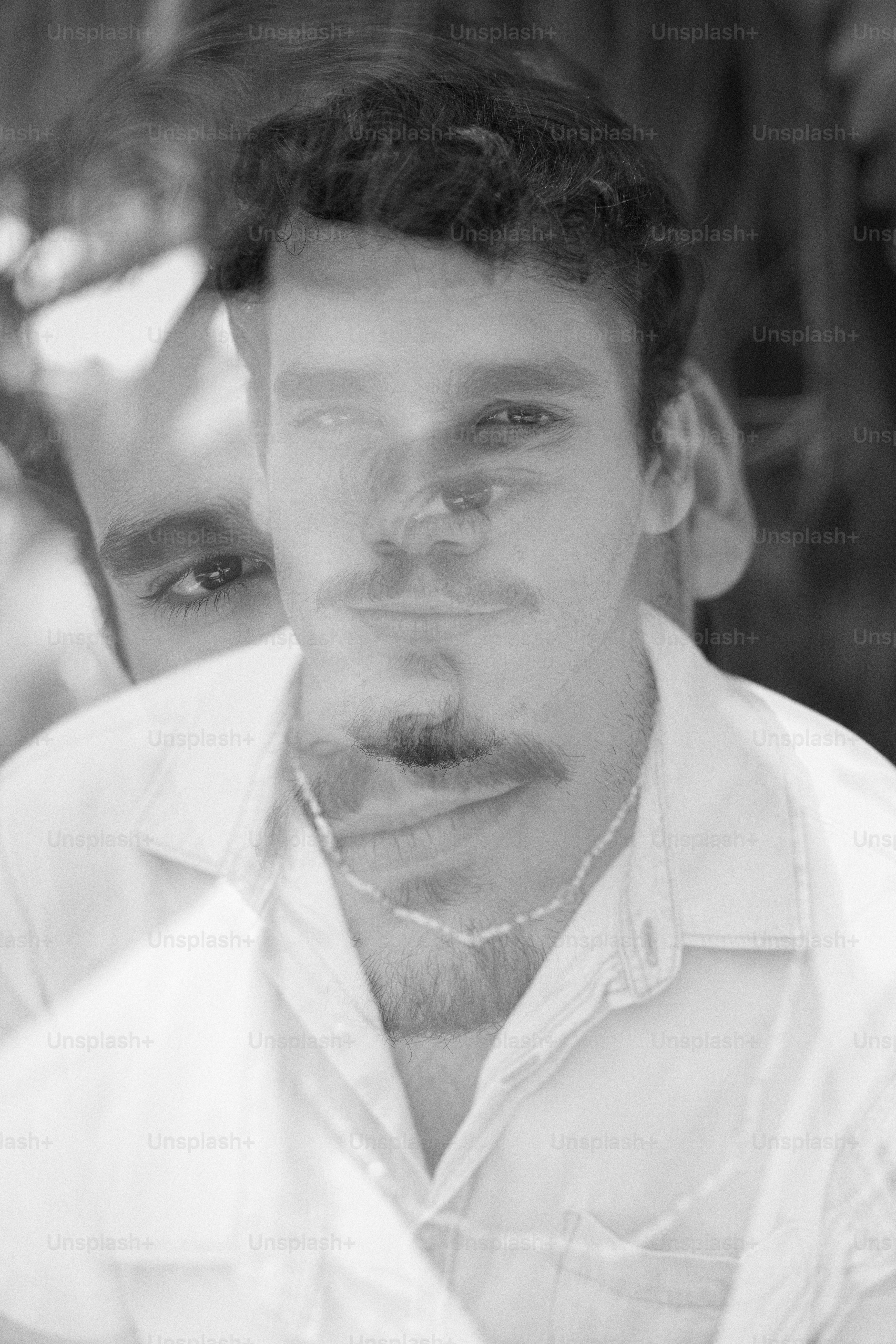 a black and white photo of a man with a beard