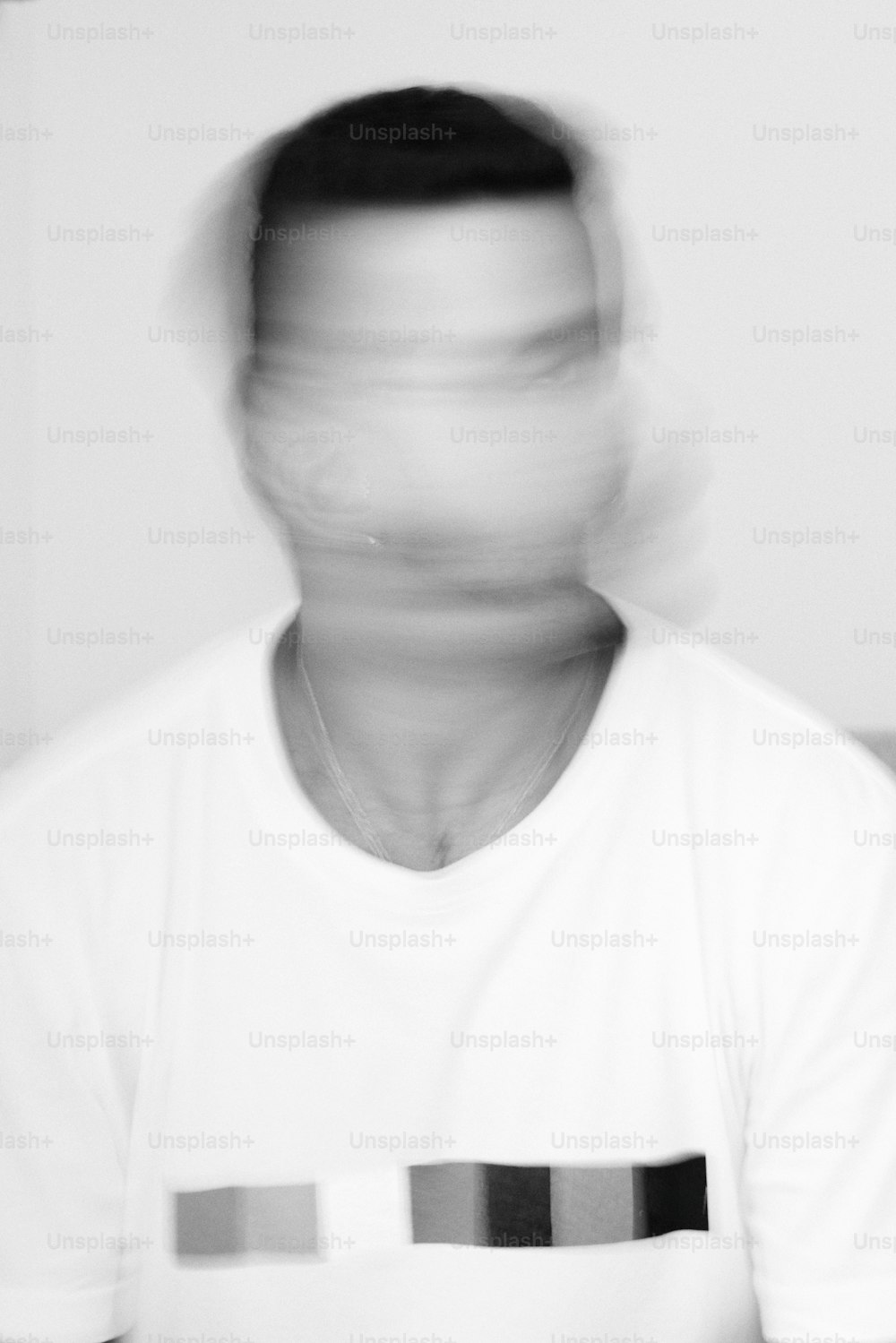 a blurry photo of a man in a white shirt