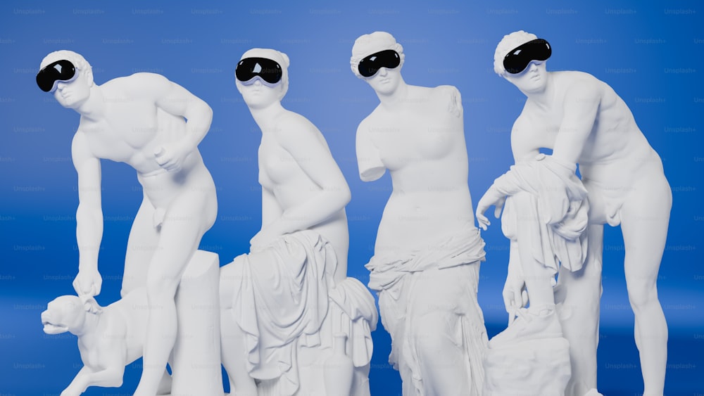 a group of white statues with blindfolded heads