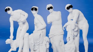 a group of white statues with blindfolded heads