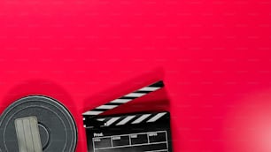 a movie clapper and a red background
