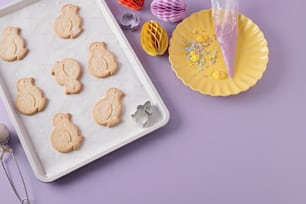 a tray of cookies next to a plate of cookies