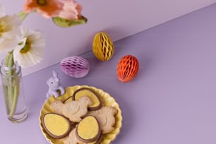 a plate of cookies and a vase of flowers