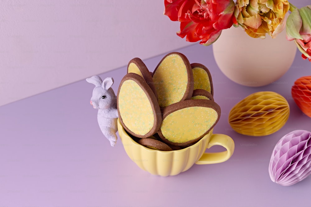 a cup with some decorations in it on a table