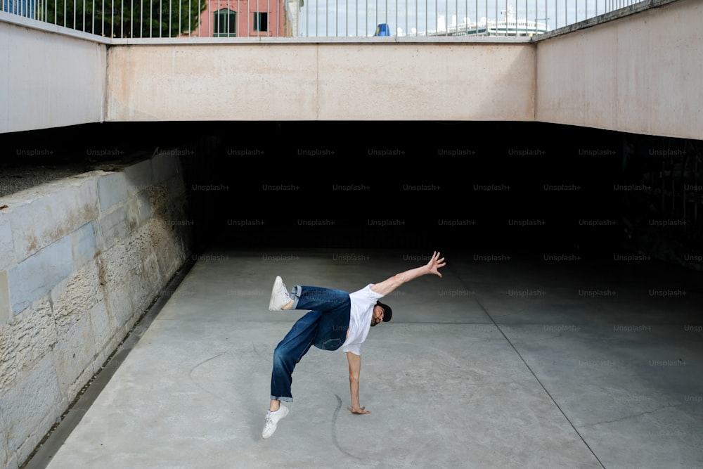 a man doing a trick on a skateboard in a tunnel