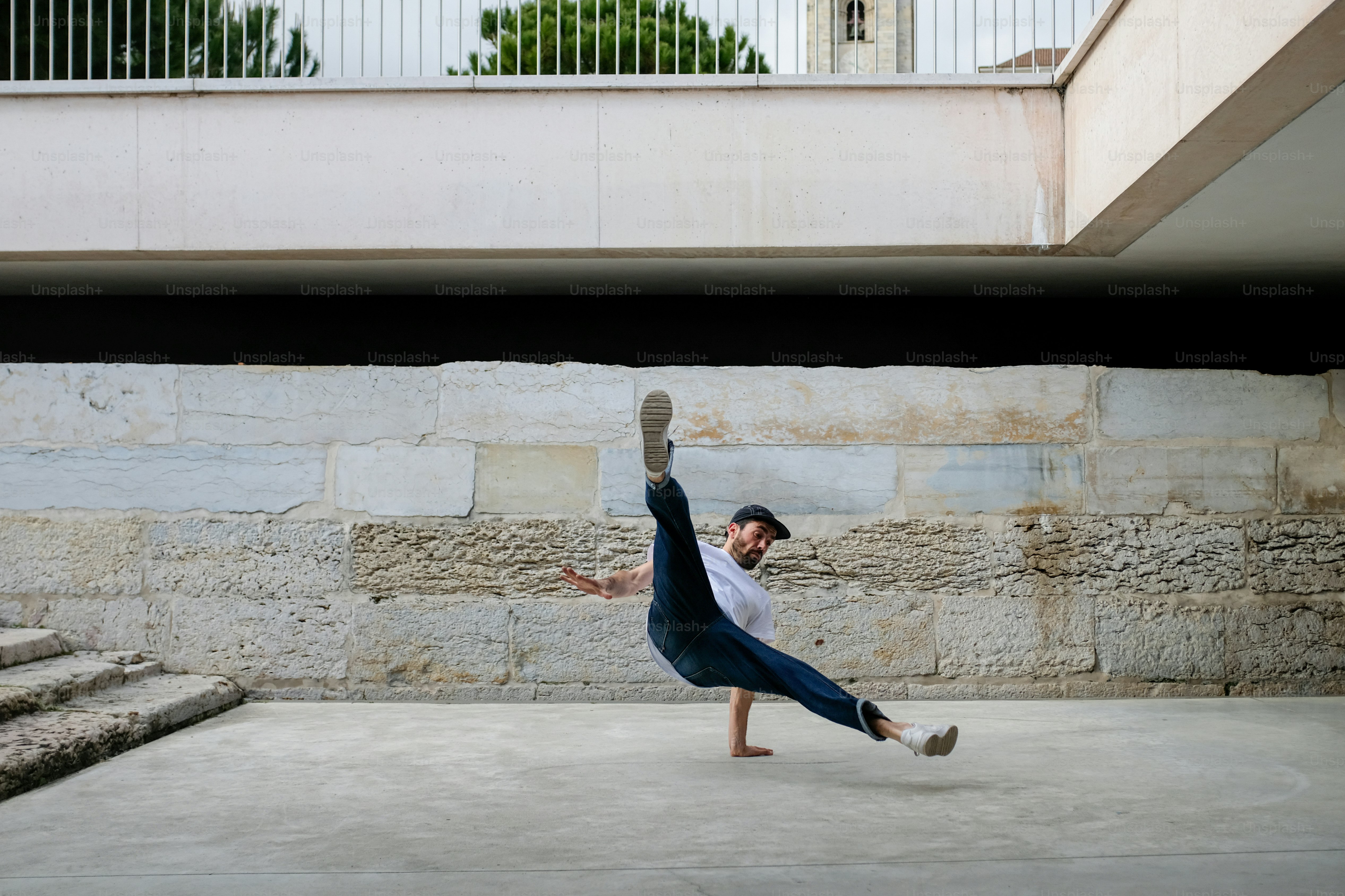 A man doing a handstand in front of a building photo – Breakdancer ...