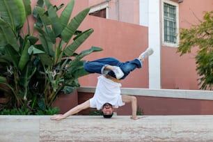 a man is doing a handstand on a ledge
