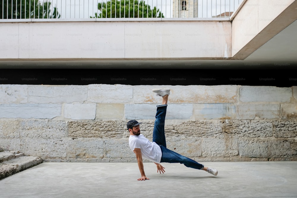 a man is doing a handstand on concrete