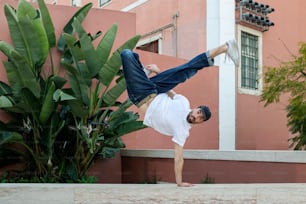 a man doing a handstand in front of a building