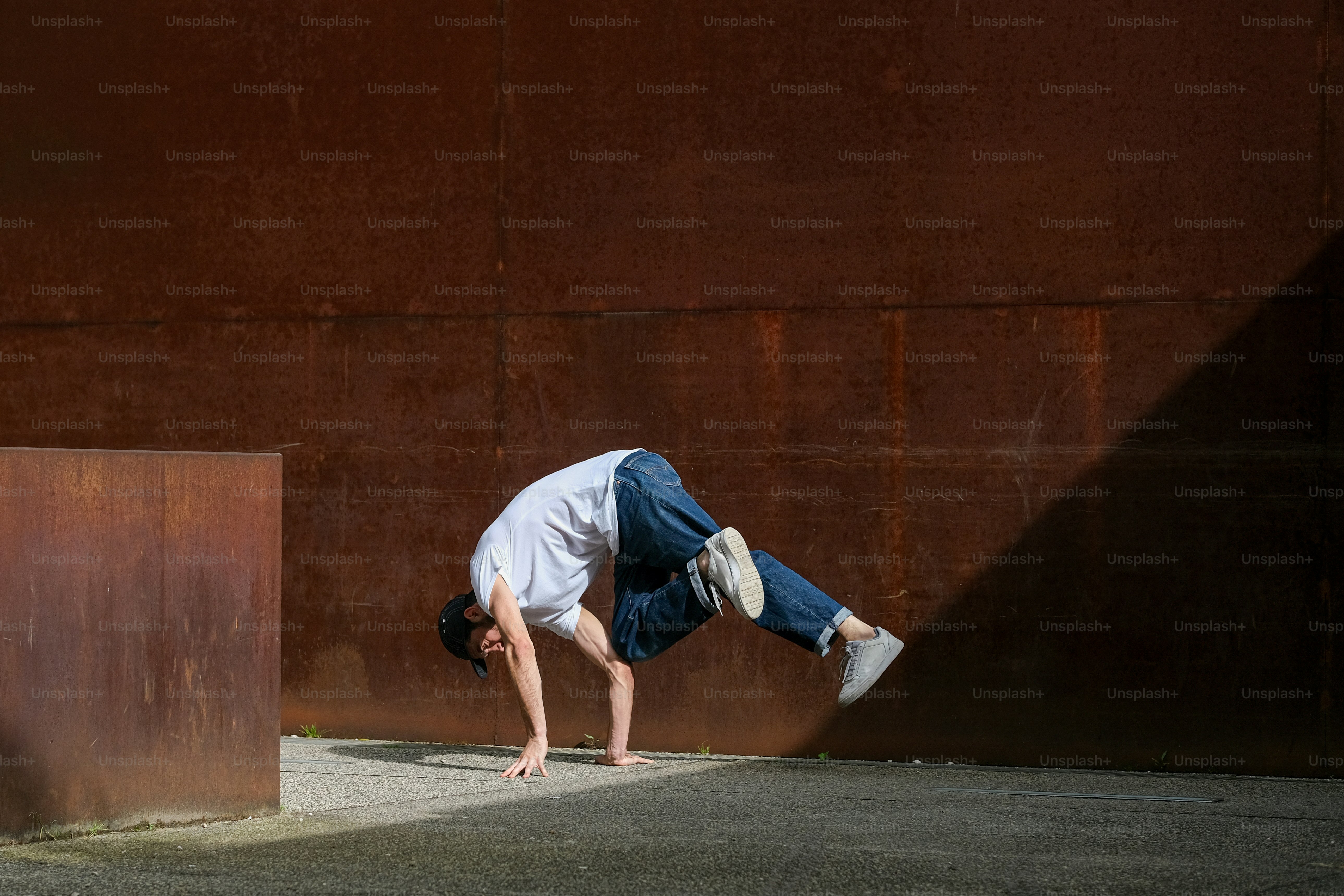 a man is doing a handstand on a skateboard