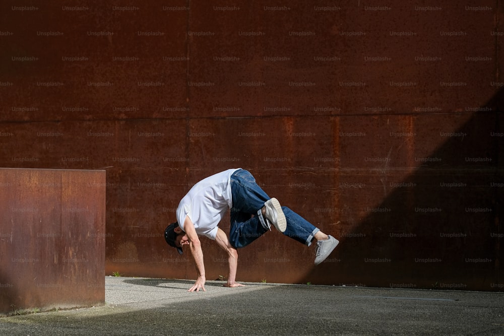 a man is doing a handstand on a skateboard