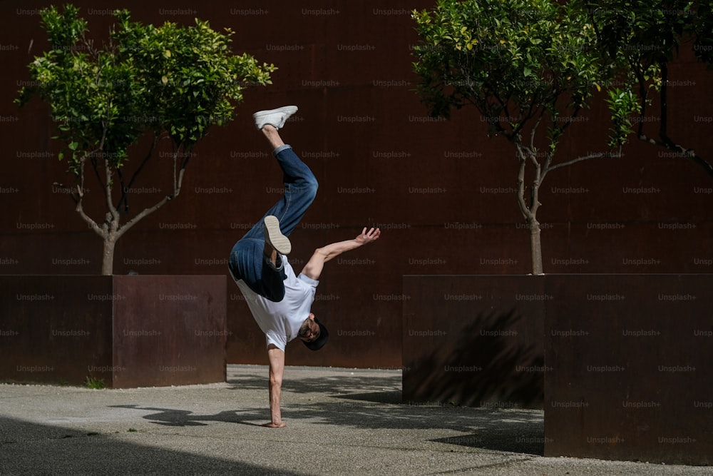 a man doing a handstand in front of a building