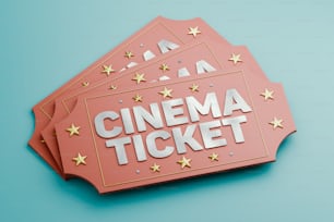 青いテーブルの上にピンクの映画館のチケットが置かれている