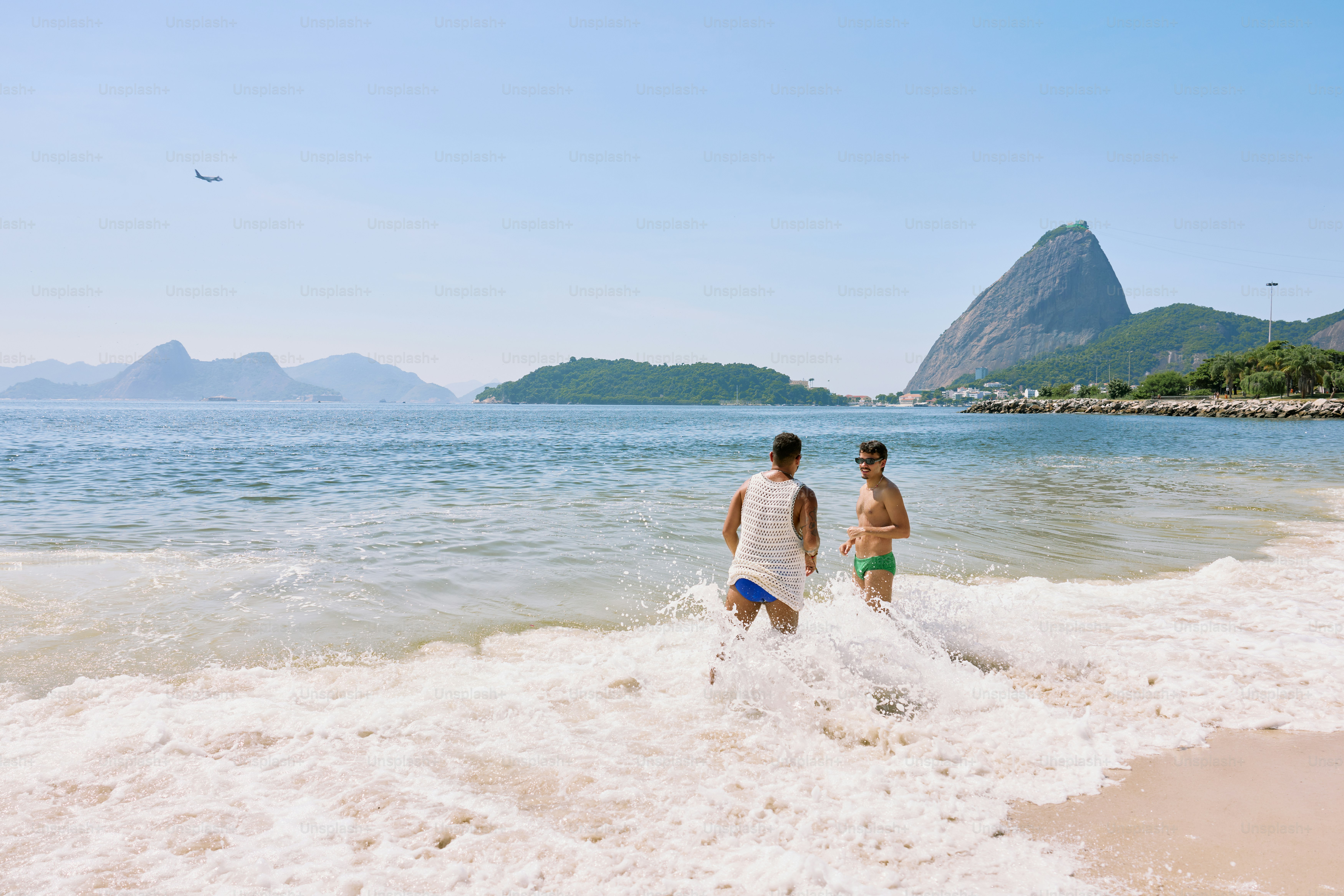 a couple of people that are standing in the water