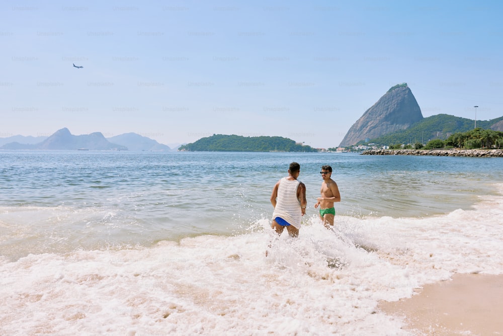 a couple of people that are standing in the water