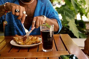 a person sitting at a table with a plate of food