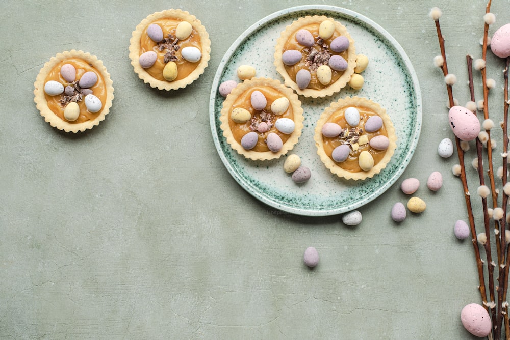 a plate topped with mini pies covered in candy