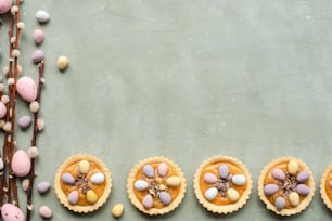 a table topped with mini pies filled with candy