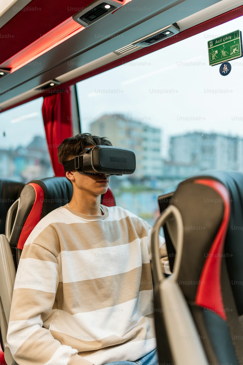 a man sitting on a bus wearing a pair of virtual glasses
