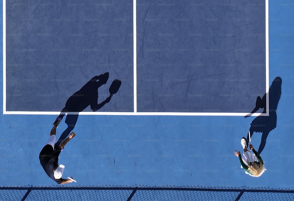 a couple of people on a court with a tennis racket