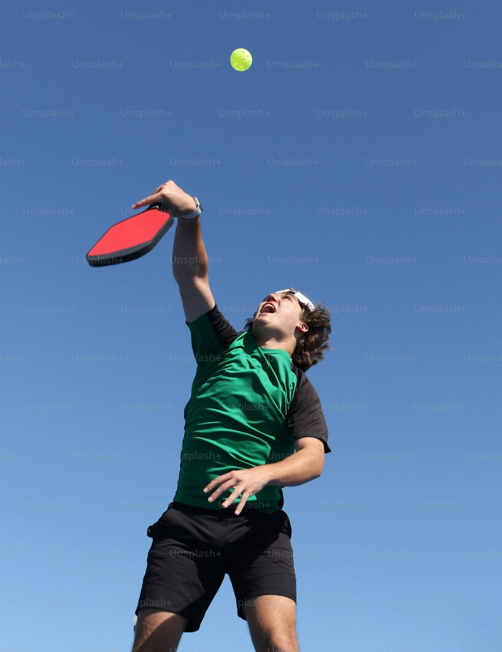 a man jumping up to catch a frisbee