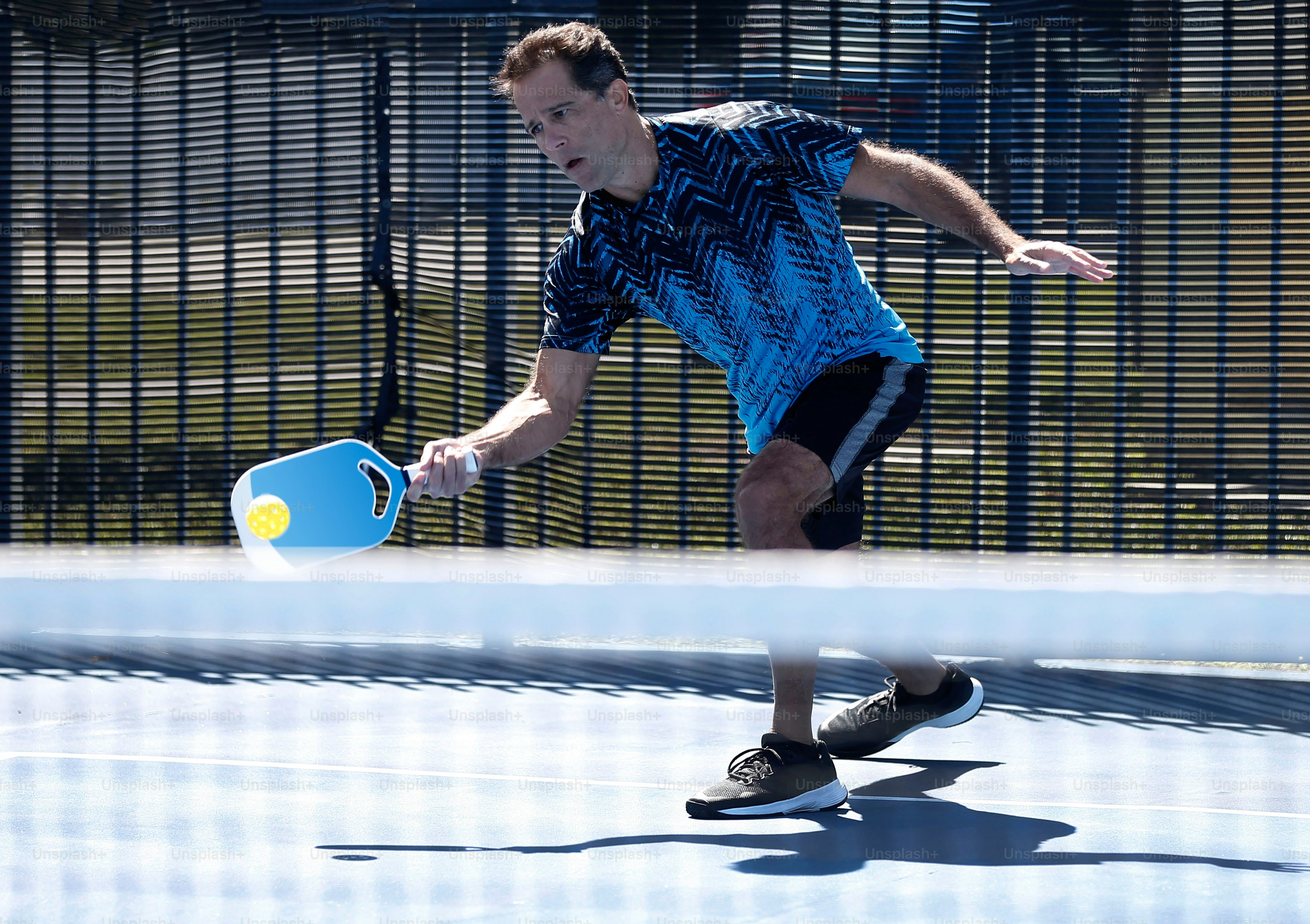 a man holding a tennis racquet on top of a tennis court
