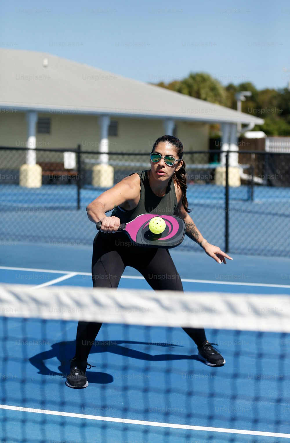 a woman holding a tennis racquet on a tennis court