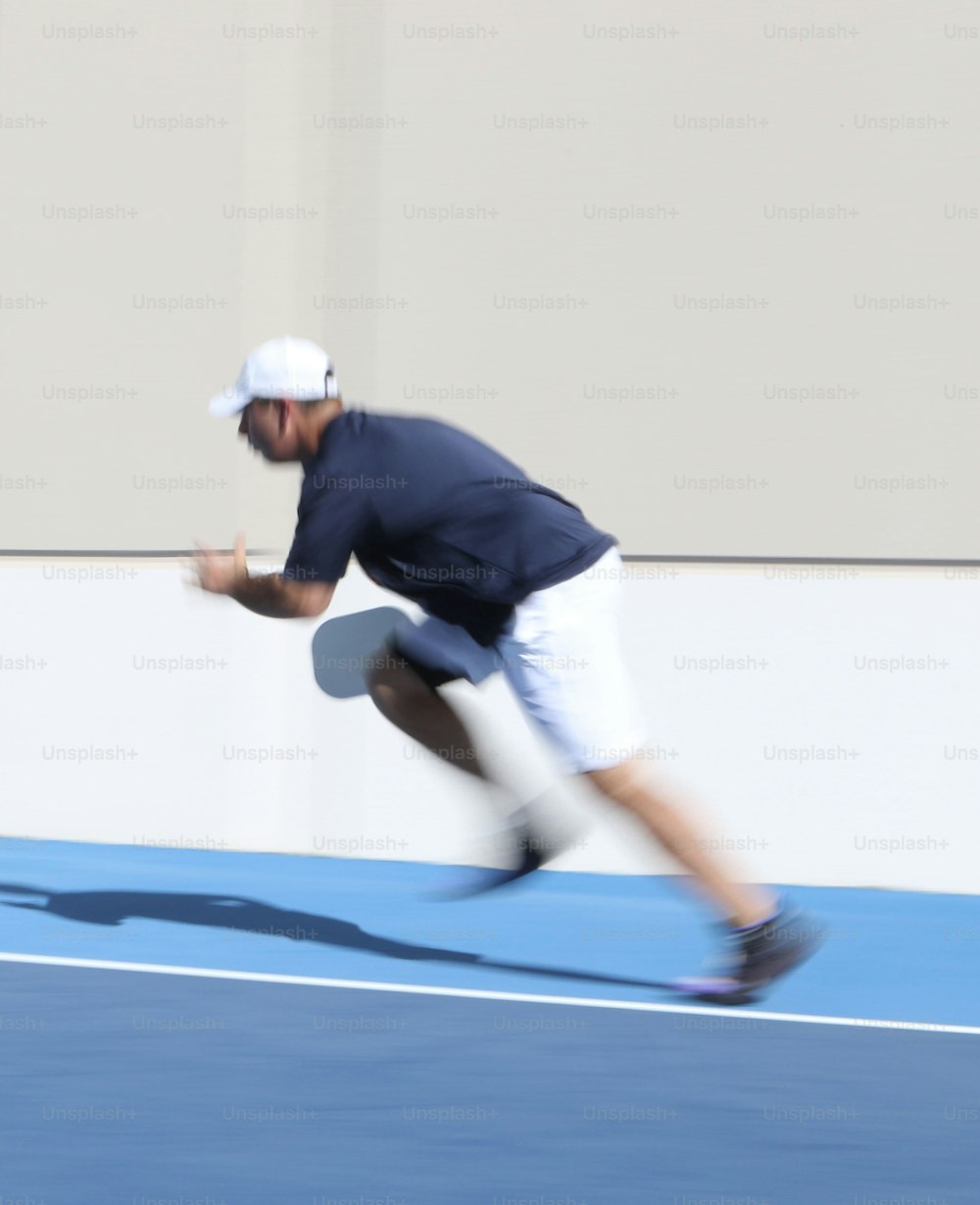 a man is running on a tennis court