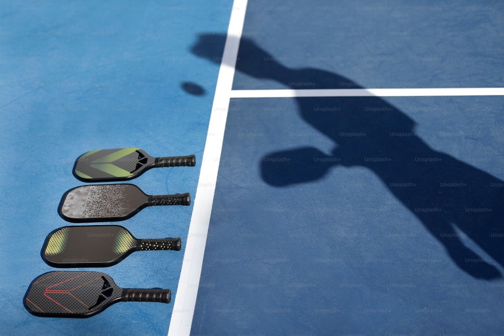 a shadow of a person on a tennis court