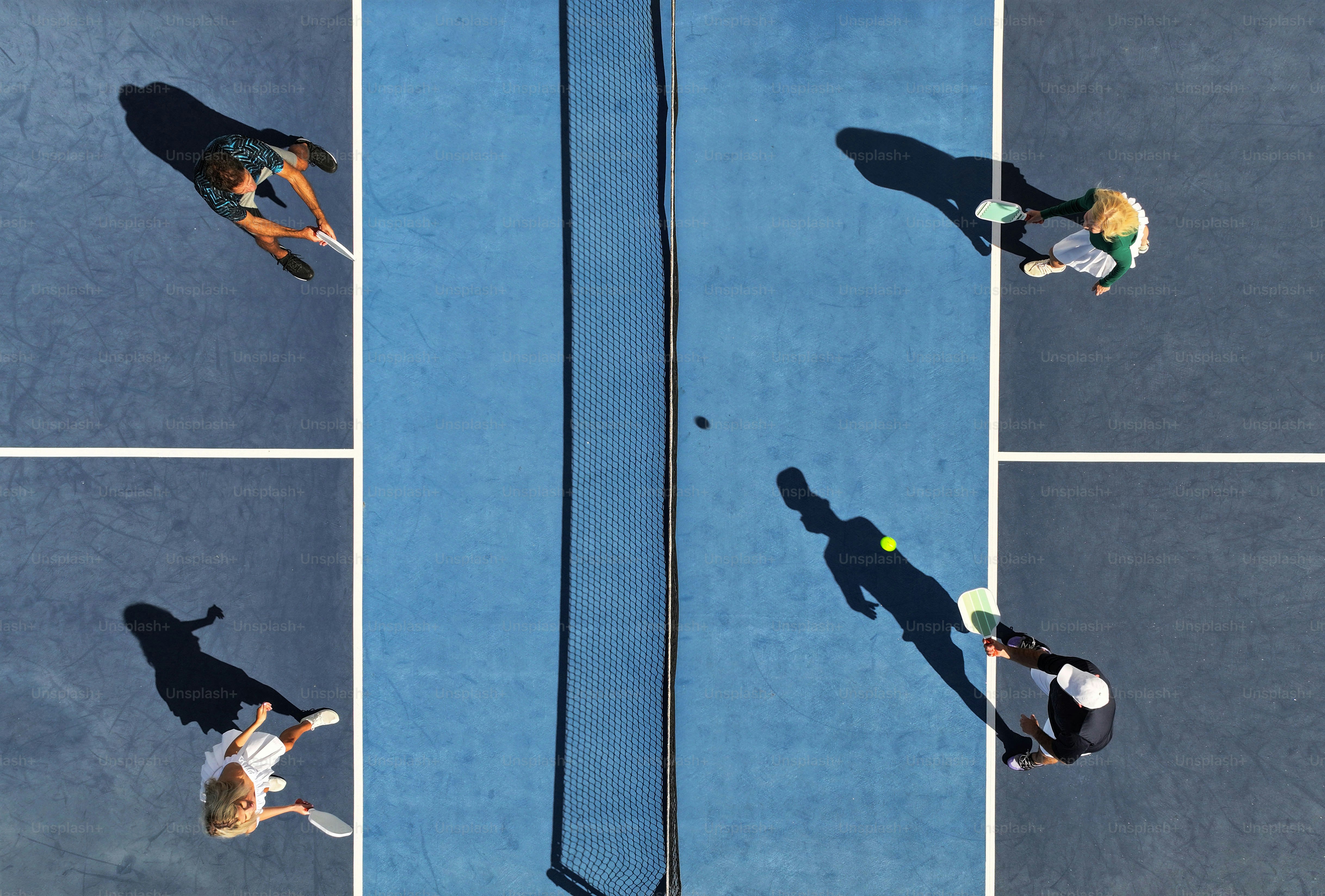 a couple of people that are standing on a tennis court